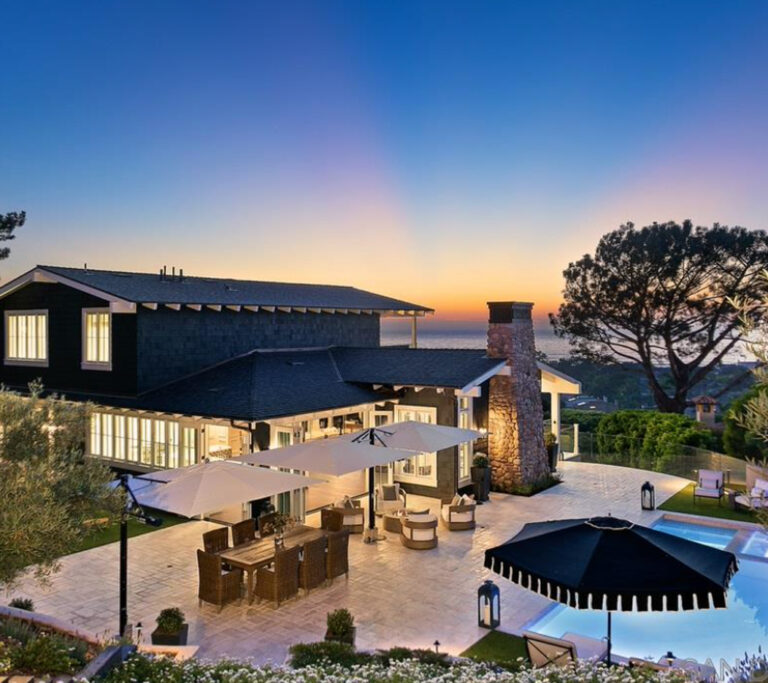 Large backyard with a pool and outdoor space with a view of the ocean.