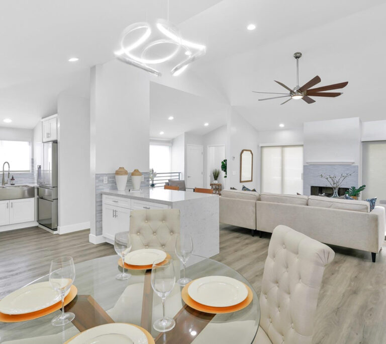 White family room and kitchen with an open floor plan.
